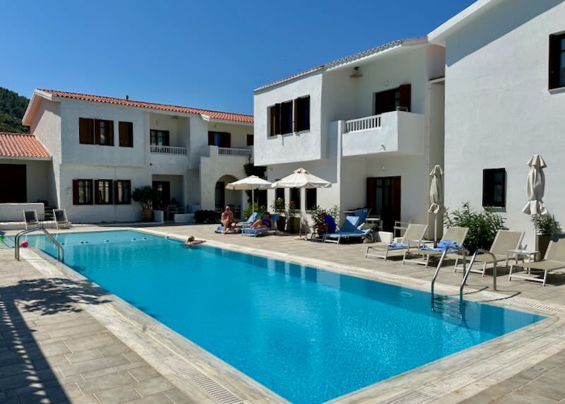 Guests swim at a basic but sparkling clean swimming pool at a hotel