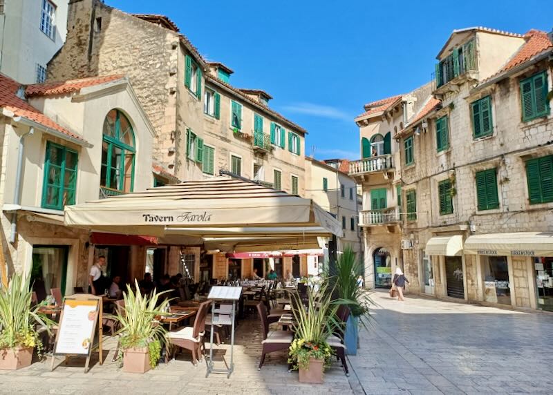 The outside of restaurants and buildings in an old town.