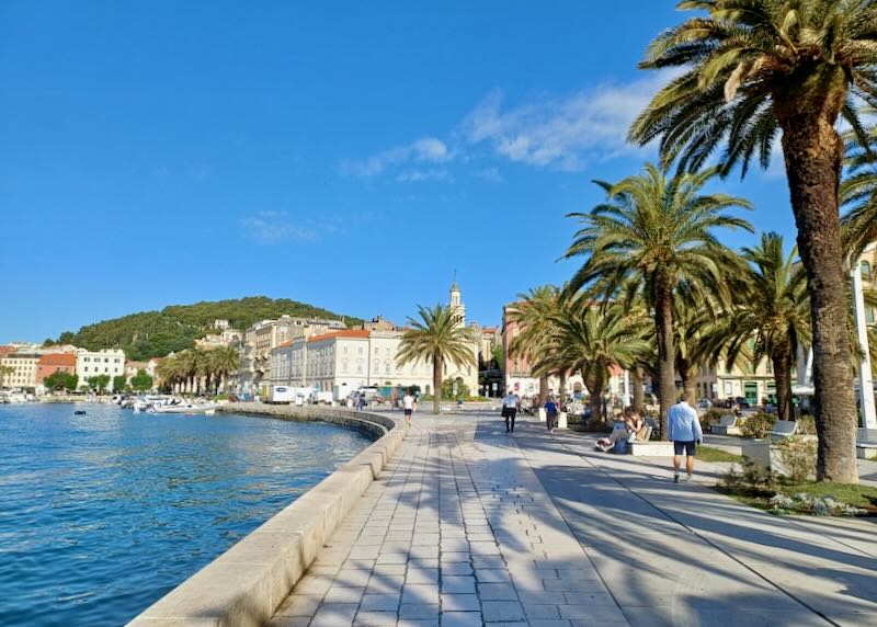 A stone pathway sits next to the water.