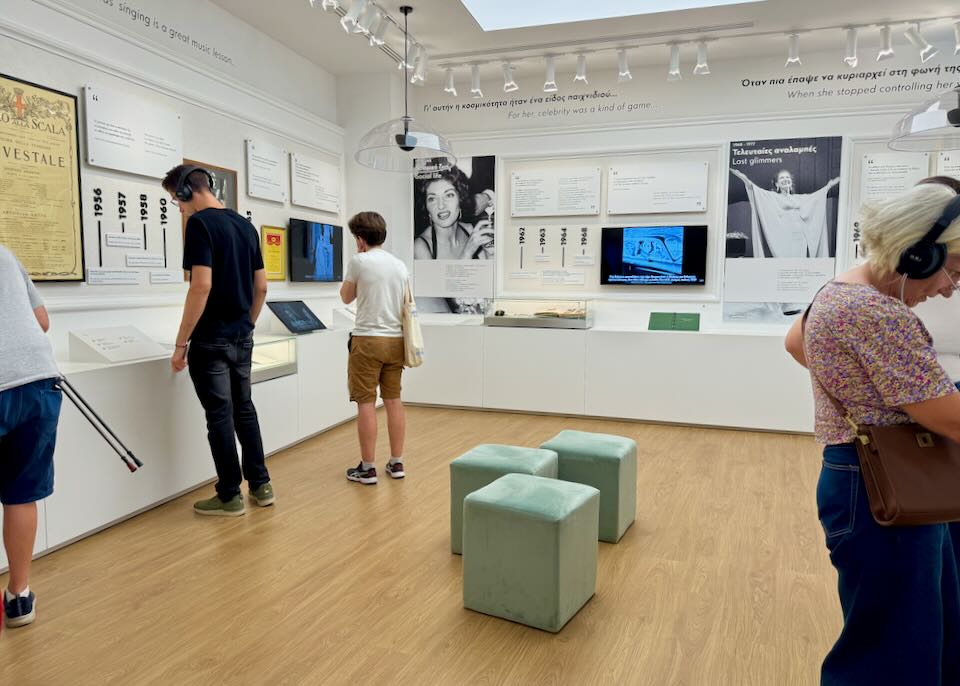 Museum visitors look at displays about the singer Maria Callas.