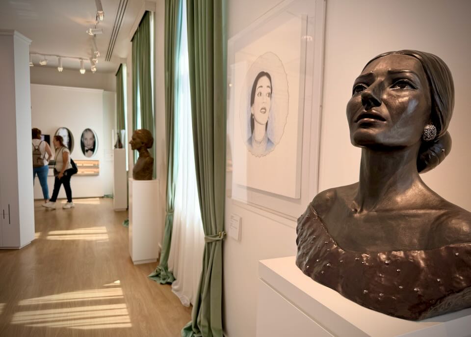 Museum display with bust of Maria Callas.