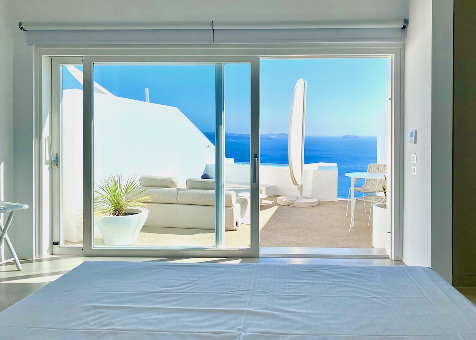 View of the caldera and terrace as seen from a bed at Saint hotel in Oia.