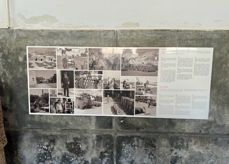 Photo display on a warehouse museum wall.