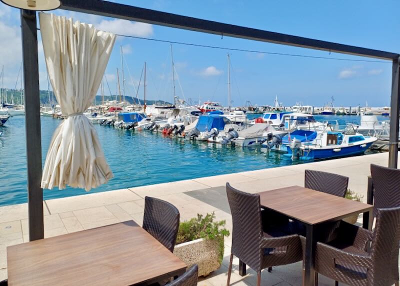Tables sit next to the marina.