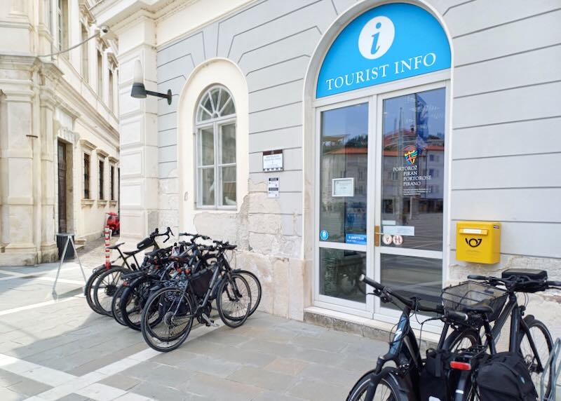 Bikes sit parked outside a tourist office.