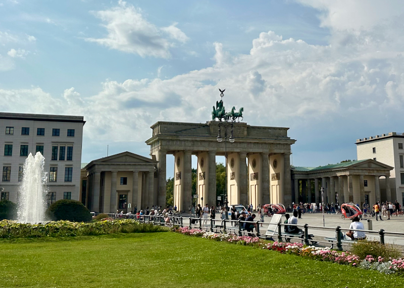 Long distance view of Berlin's Brandonberg Gate, with flowers blooming nearby