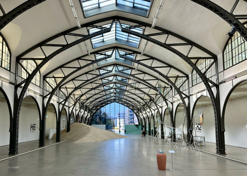 Large cavernous art gallery space with vaulted white ceiling