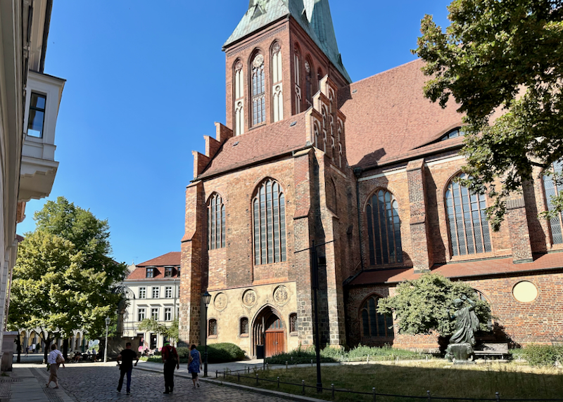 Red brick church on a leafy street