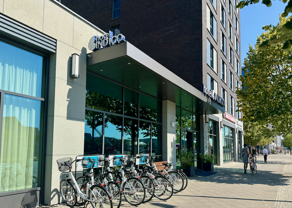 Hotel entrance with a row of bikes parked in front