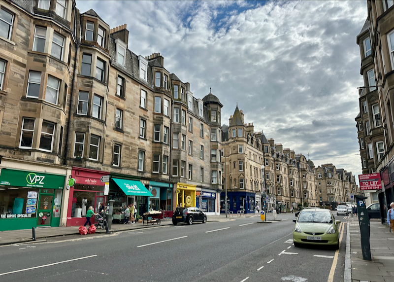 Rows of old Scottish buildings line a street in Edinburgh