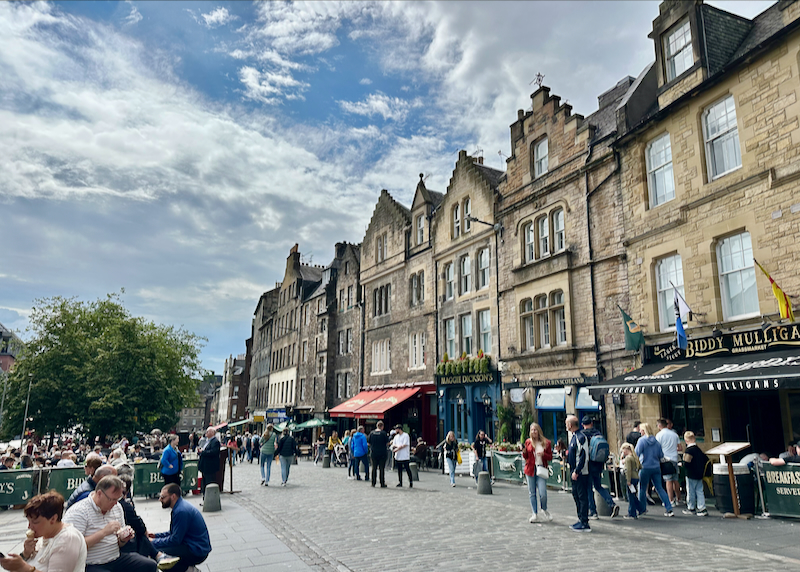 Pedestrian cobbled square surrounded by medieval buildings in Scotland