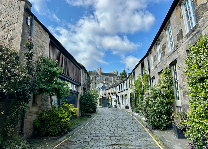 Narrow stone lane flanked with adjoined stone buildings