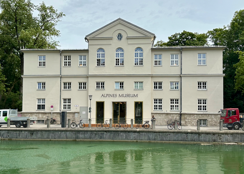 Classic white museum building, reflected in water below