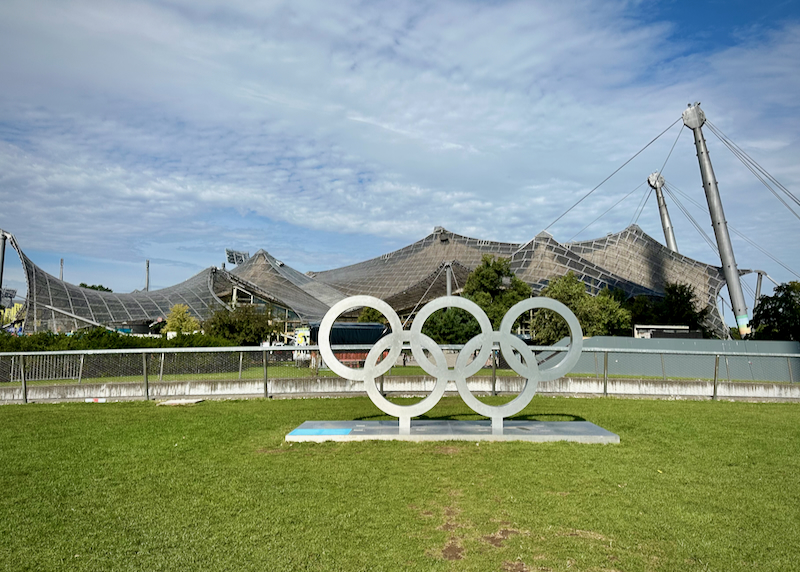 Large Olympic rings and tent-like buildings at Olympiapark in Munich