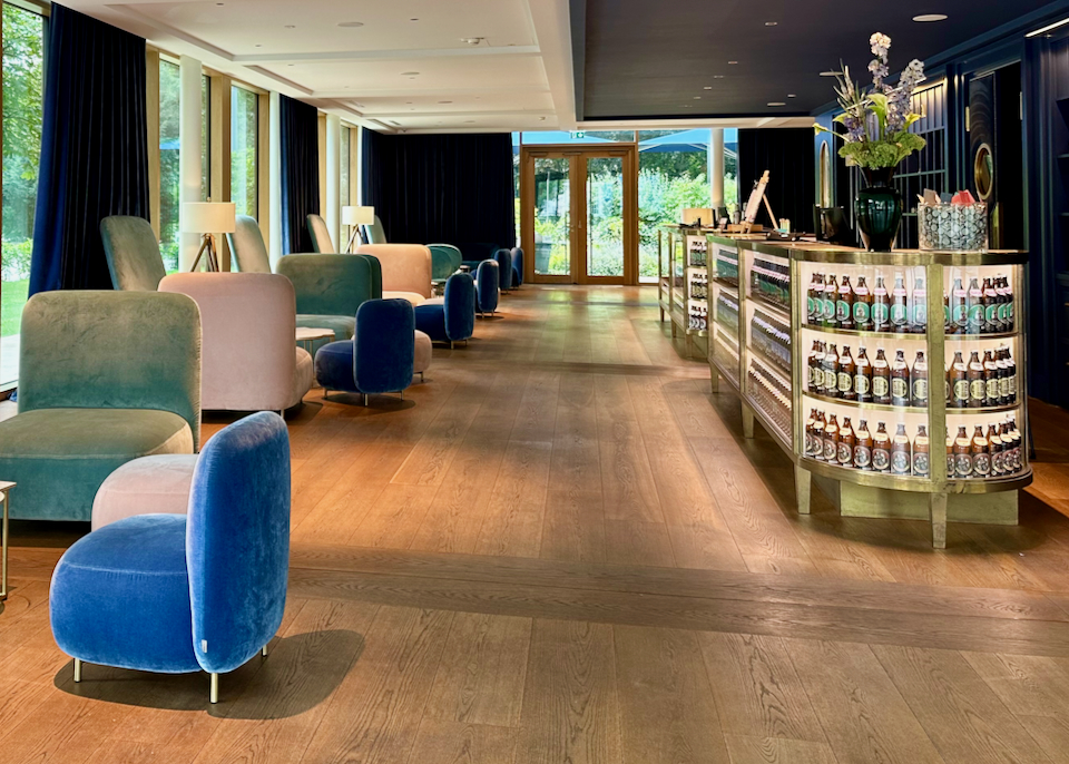Bright and airy hotel restaurant with velvet padded chairs