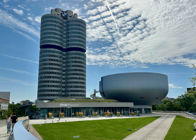 Large tower and curvilinear building of the BMW Museum in Munich.