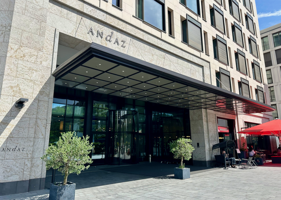 Modern hotel entrance with cafe tables in front