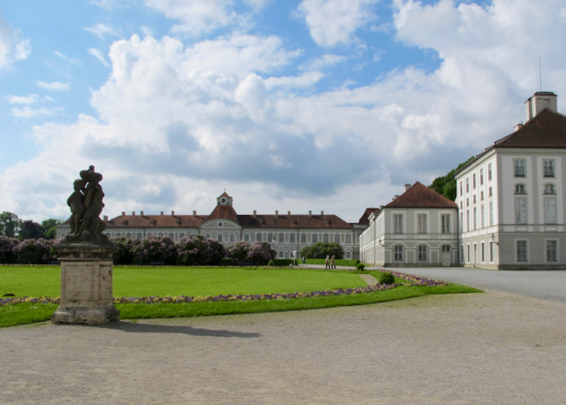 Gravel drive leading past a statue to the buildings of Schloss Nymphenburg in Munich