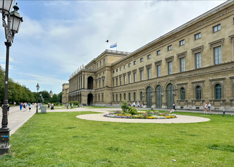 Large green space backed by a magnificent palace building