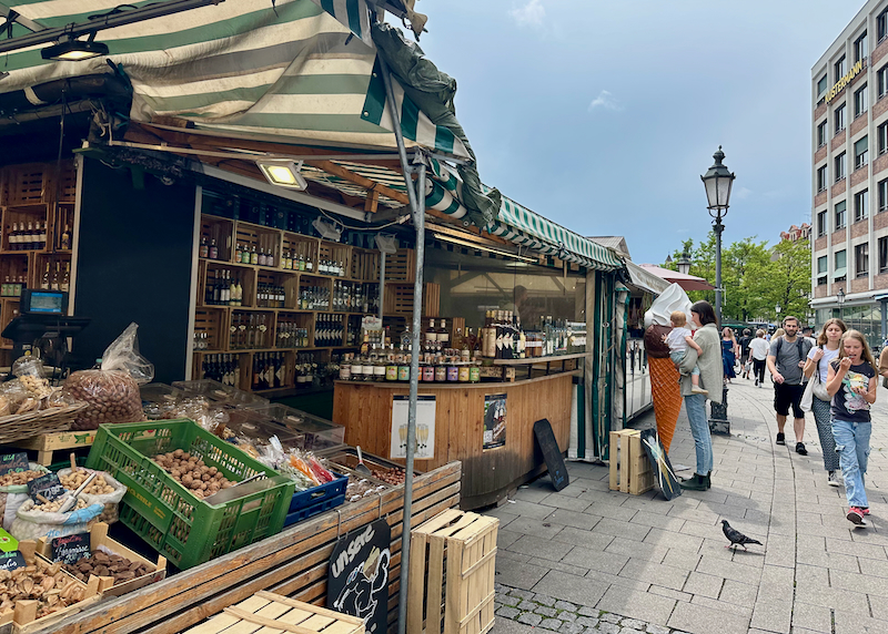 People buy nuts at a market stand