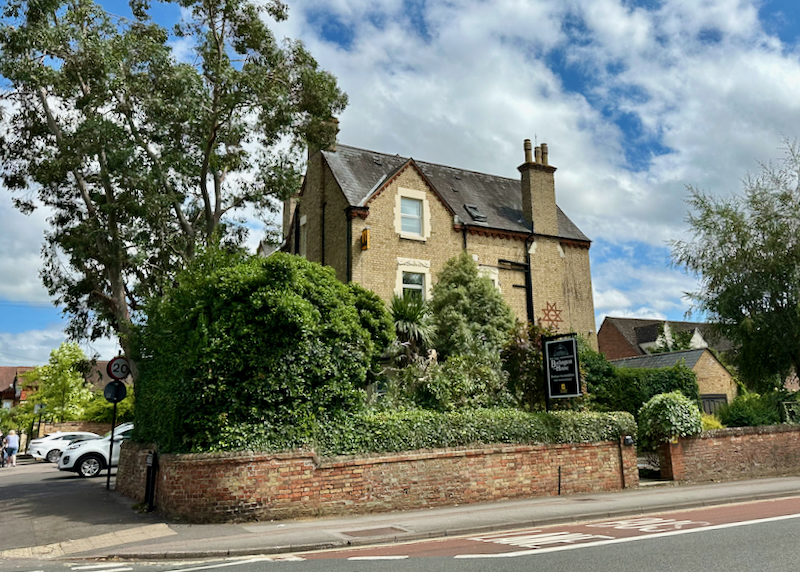 Exterior view of an old stone hotel.