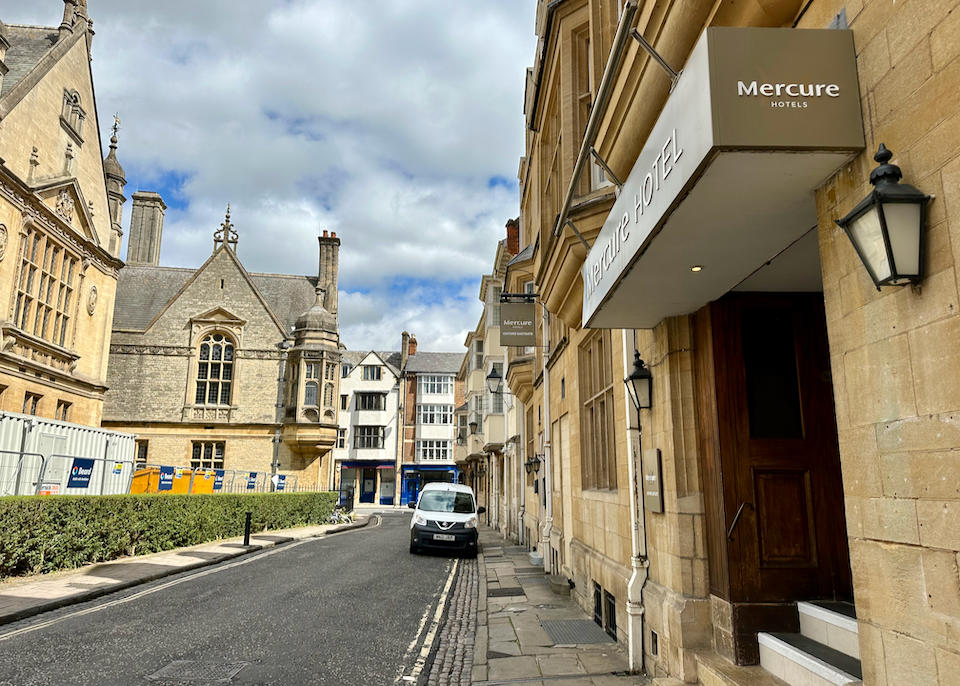 View looking down a quiet street in Oxford, with the entrance to the Mercure Hotel in the foreground