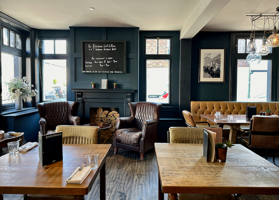 English inn pub room with stuffed leather chairs and a fireplace