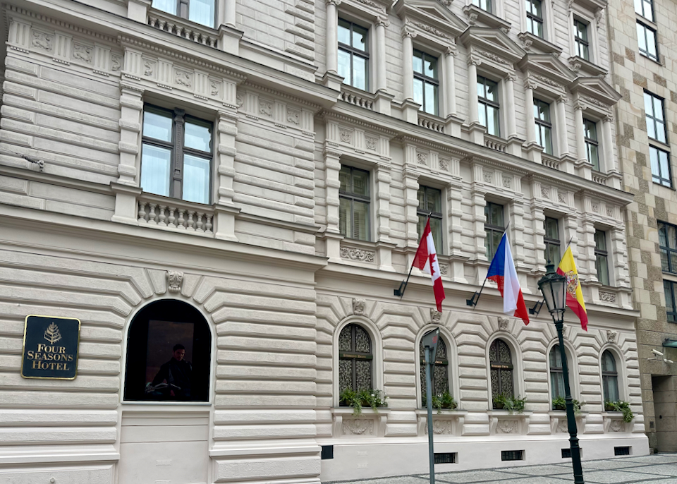 Exterior of the Four Seasons hotel in Prague, with national flags flying in front
