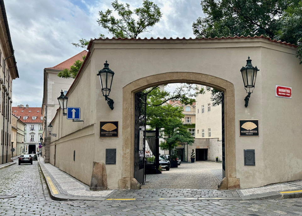 Entrance from the street, leading to the courtyard of a luxury hotel in Prague