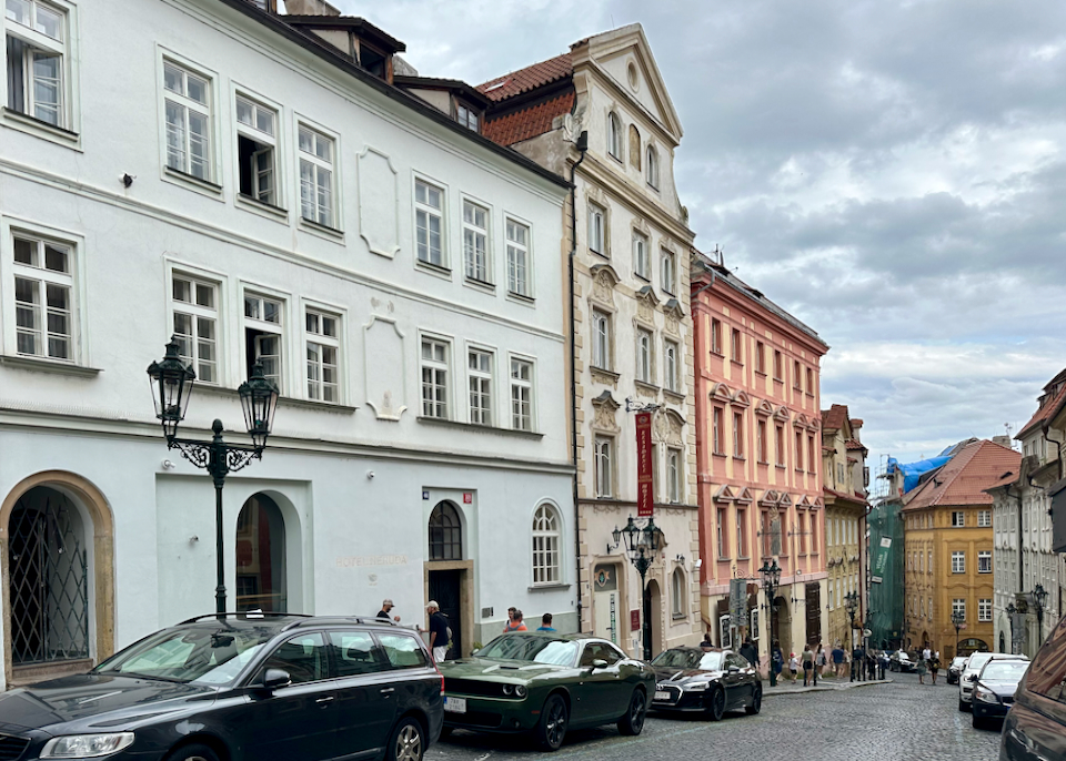 Row of colorful townhouse buildings in Prague, with one being a boutique hotel