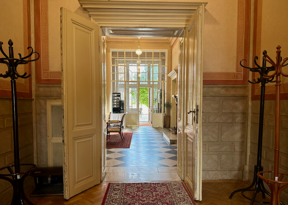 Light shines through open glass doorways in a boutique hotel
