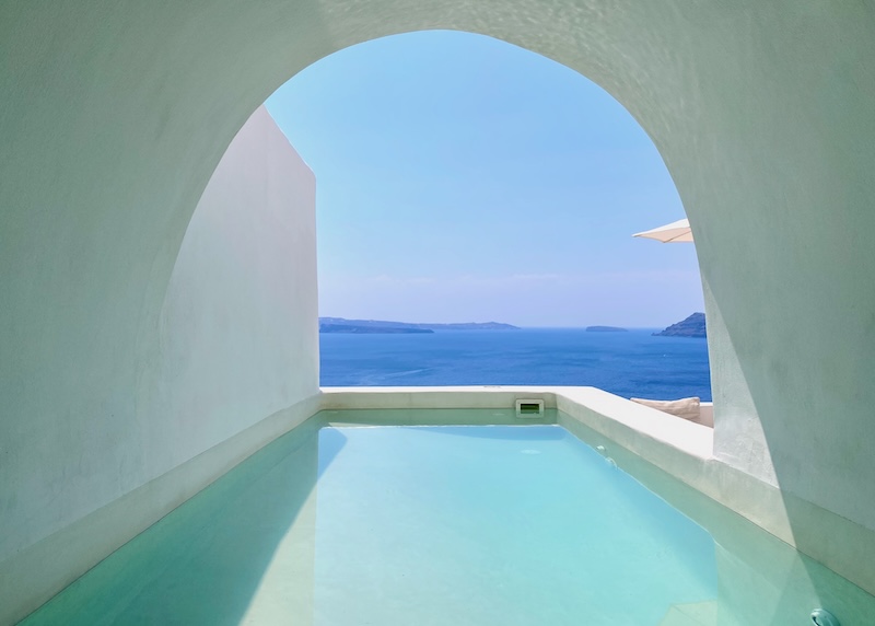 View from inside a covered, indoor-outdoor cave pool at Armenaki hotel in Oia.