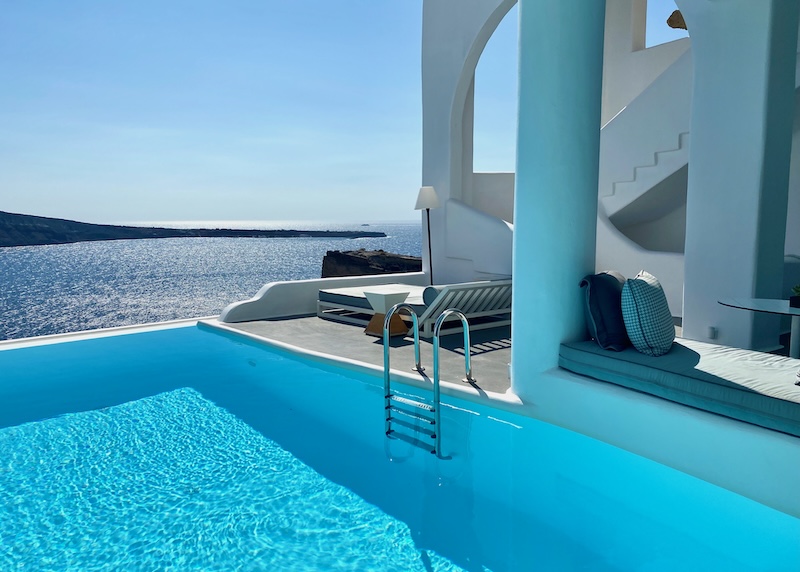 A covered cave pool supported by columns with a view to the caldera at Charisma Suites in Oia.