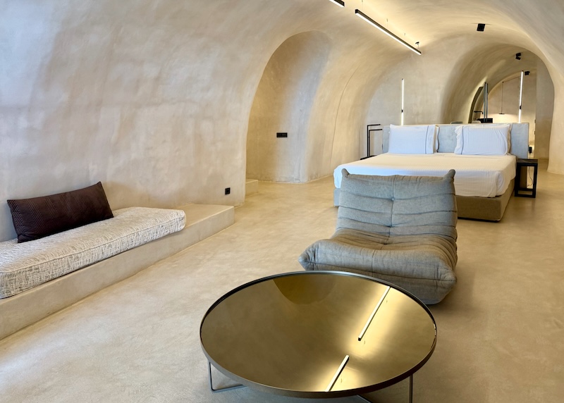 A large cave suite with contemporary, minimalist decor at Divine Cave Experience in Imerovigli.