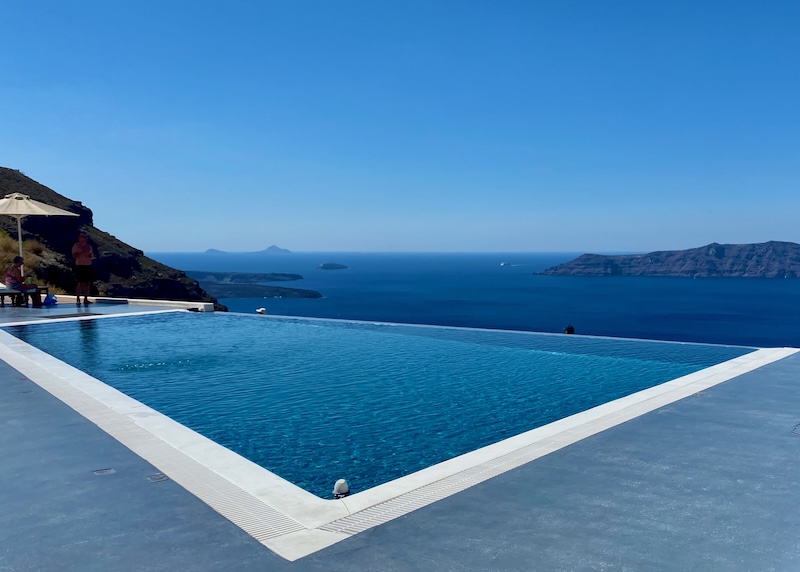 Infinity pool above the caldera facing Thirassia and the volcanoes at Anastasis Apartments in Santorini.