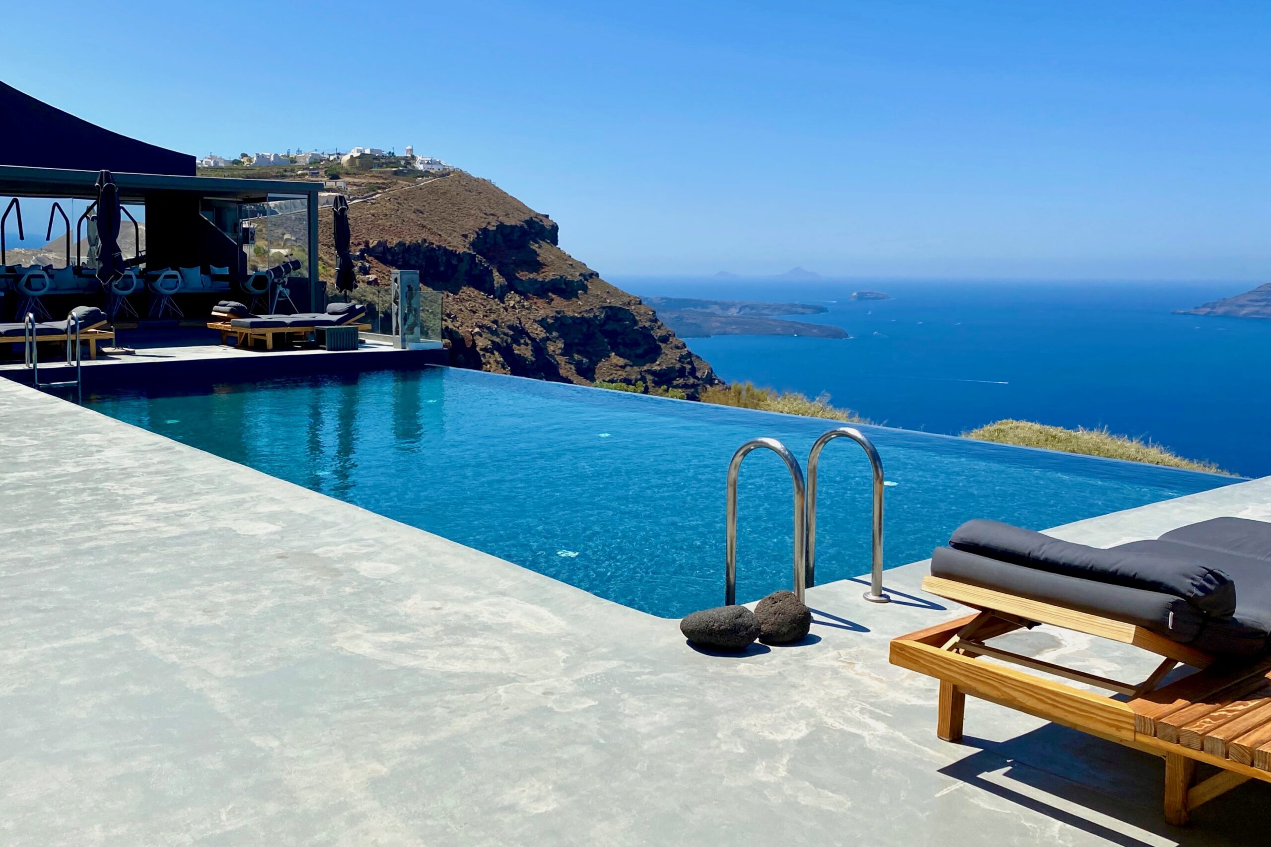 Ininity pool next to the bar and overlooking the caldera at West East Suites in Santorini.