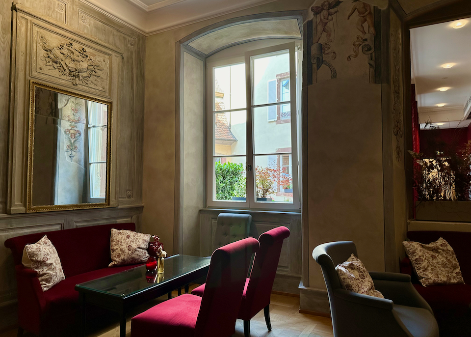 Moody interior of an elegant historic building, with light streaming in the windows