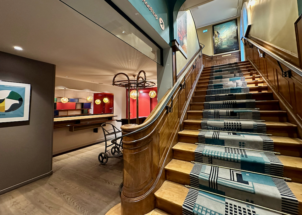 Interior of a boutique hotel with curved wooden stairway