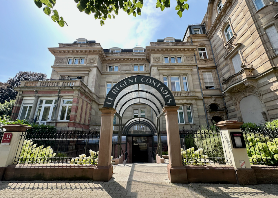 View looking in through the front gate of an ornate luxury hotel building
