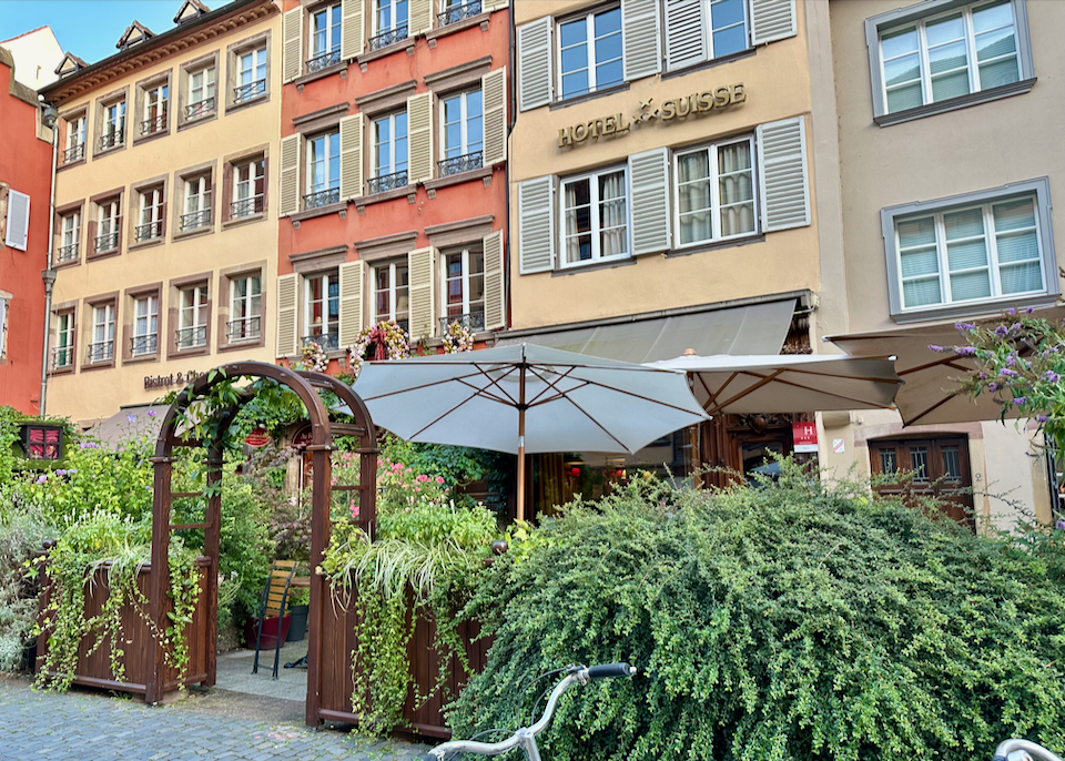 Exterior of a boutique hotel, with a cafe terrace in front