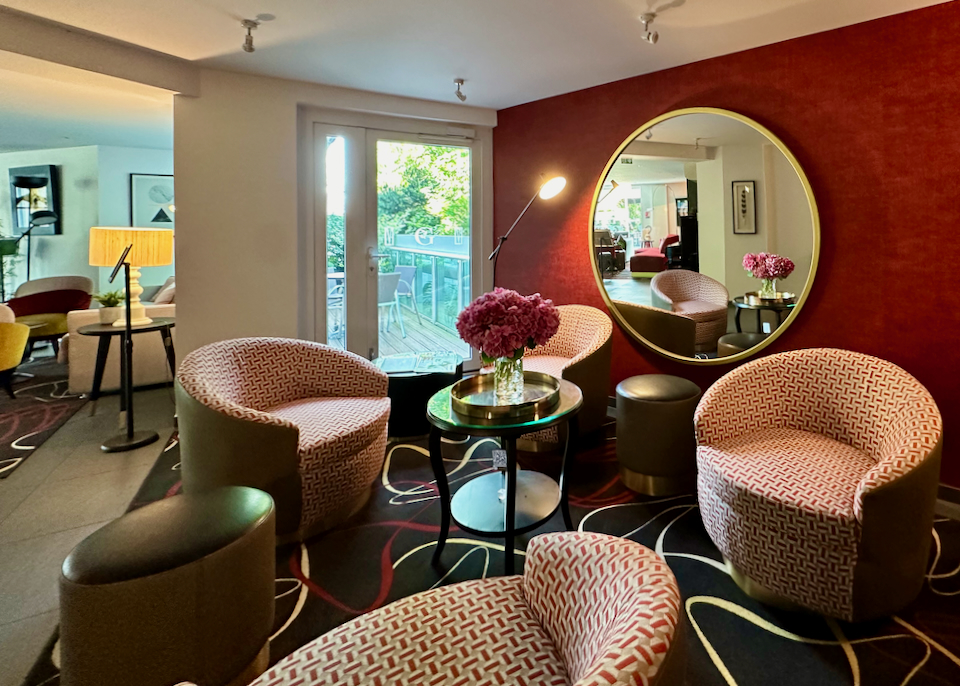 Hotel lobby with lounge chairs and a circular mirror