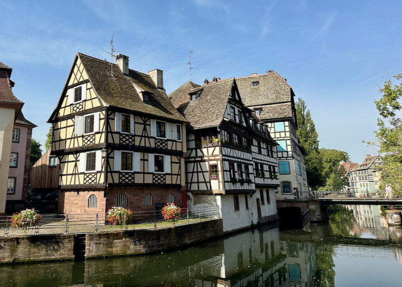 Alscacien-style buildings along a river.