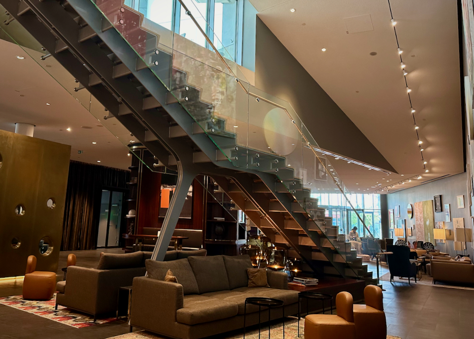 Modern hotel lobby with geand glass staircase.