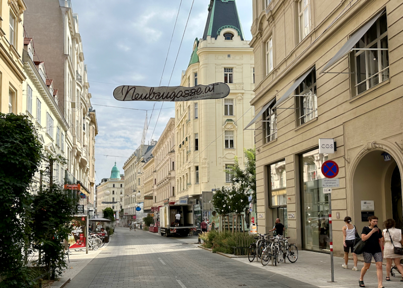 Narrow street in Vienna, lined with shops and cafes