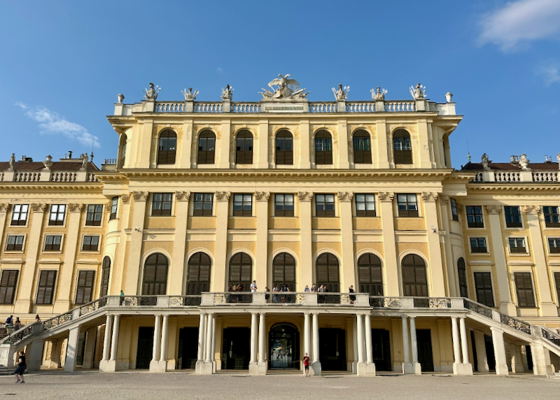 The exterior entrance of Schönbrunn Palace in Vienna at dusk