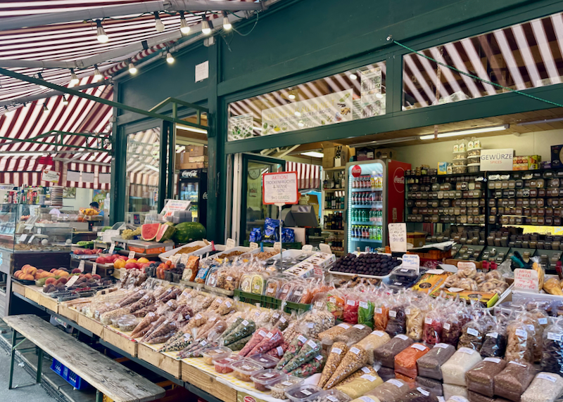 Market stand piled with nuts and colorful spices 
