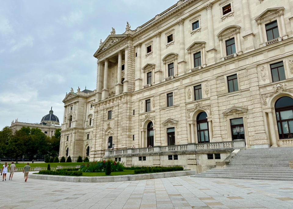 Tourists walk past the Hofburg Palace in Vienna