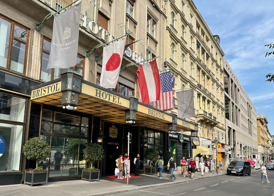 Luxury hotel entrance with flags flying over the awning