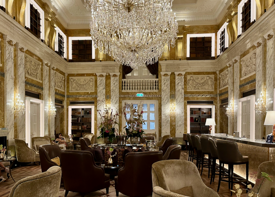 Grand hotel dining lounge with bar and crystal chandelier
