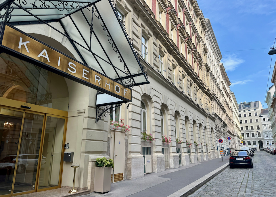 Entrance to a historic luxury hotel on a narrow street